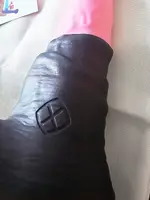 The dark wrinkled sheath and base with the maker's logo