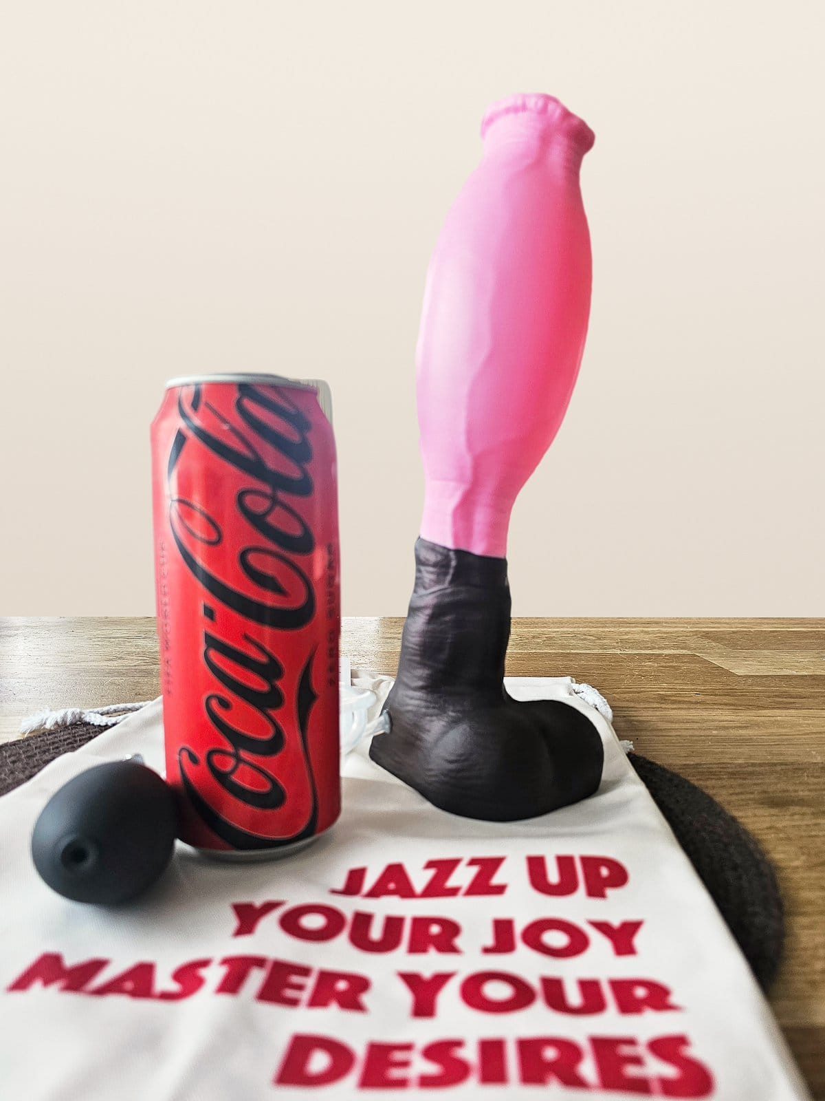The Chironax inflated next to a half-liter soda can, the shaft swollen into a smooth oval