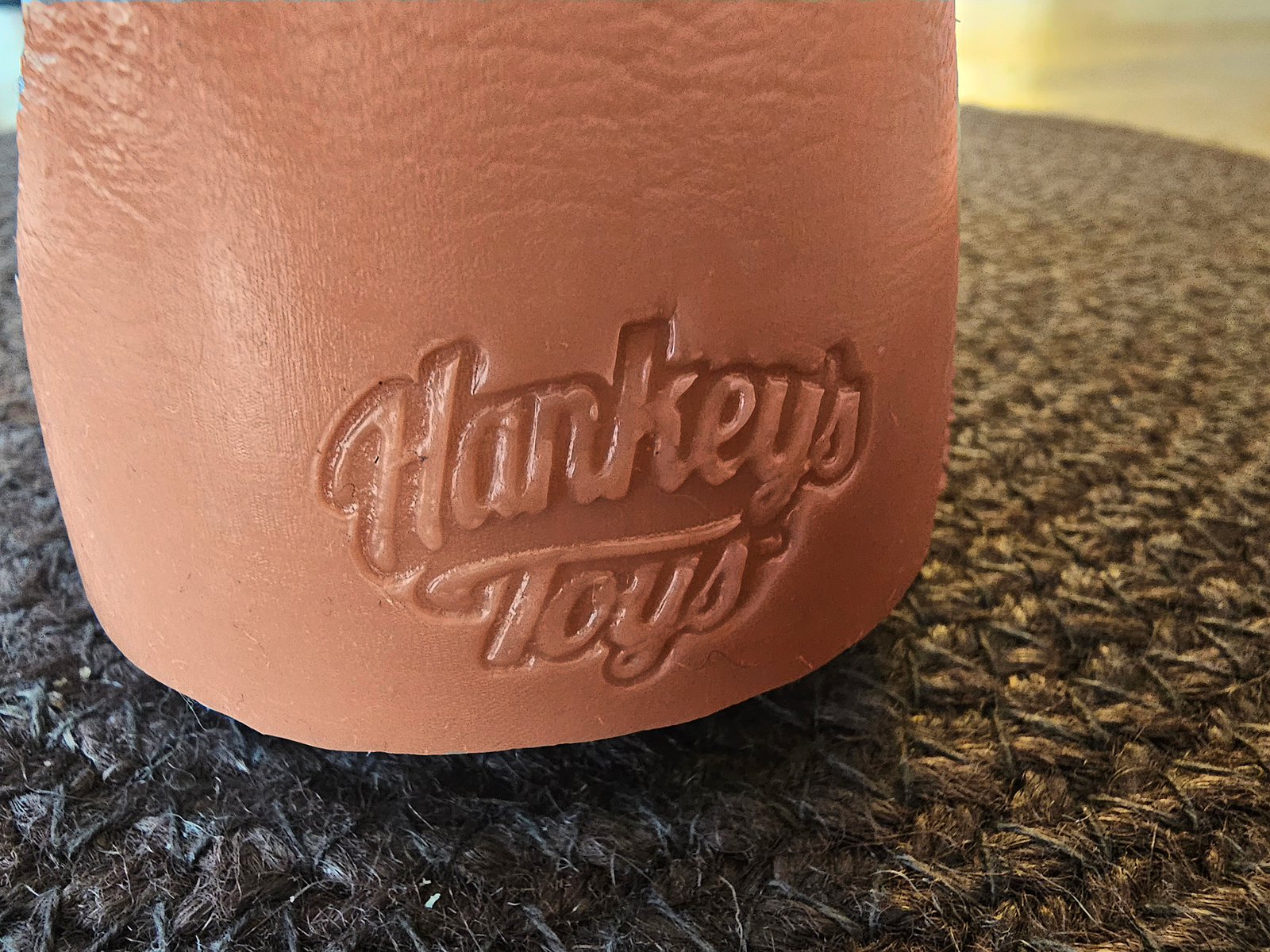 The Hankey's Toys logo pressed into the silicone at the base