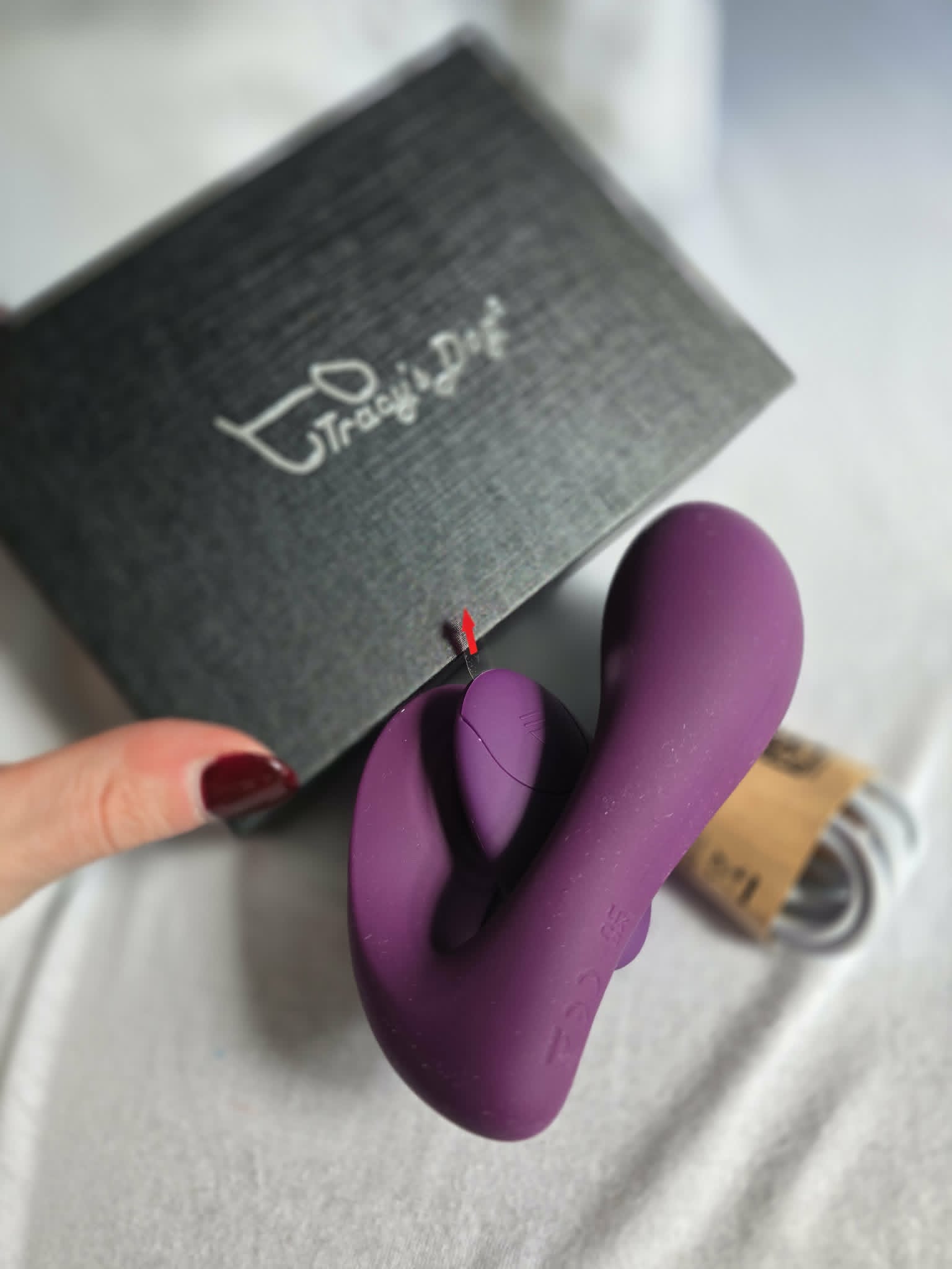 Main toy held in hand showing the U-shape and the clitoral arm position